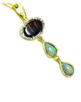 Black and white Australian opal pendant in 14K yellow gold with diamond halo and two dangling teardrop opals.