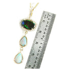 Black and white Australian opal pendant in 14K yellow gold with diamond halo and two teardrop opals.