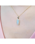 14K yellow gold necklace with a rectangular Australian opal pendant encircled by diamonds.