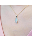 14K yellow gold necklace with a rectangular Australian opal pendant encircled by diamonds.