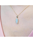 14K yellow gold necklace with a rectangular Australian opal pendant encircled by diamonds.