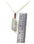 14K yellow gold pendant necklace with a colorful opal and diamond halo, next to a ruler.