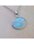 2.25 ct Australian opal pendant in 14K white gold, east-west bezel set with bluish-green flashes.