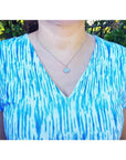2.25 ct. Australian opal pendant in 14K white gold, east-west bezel set, with bluish-green flashes.