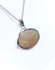2.25 ct Australian opal pendant in 14K white gold, east-west bezel set, with bluish-green flashes.