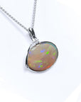 2.25 ct Australian opal pendant in 14K white gold, east-west bezel set, with bluish-green flashes.