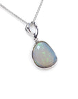 Freeform bluish-green Australian opal pendant, bezel set in 14K white gold with a chain.