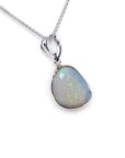 Freeform bluish-green Australian opal pendant, bezel set in 14K white gold with a chain.