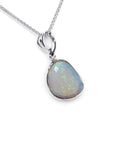Freeform bluish-green Australian opal pendant, bezel set in 14K white gold with a chain.