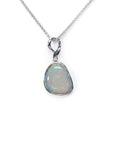 Freeform bluish-green Australian opal pendant, bezel set in 14K white gold on a silver chain.