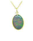 Oval Australian opal pendant with green-bluish rainbow play, set in 14K yellow gold.