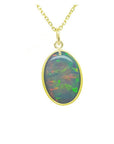 Oval Australian opal pendant with green-bluish rainbow play, set in 14K yellow gold.