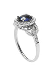 1.08 ct oval blue sapphire ring in 14K white gold with diamond halo and accents.