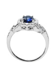 1.08 ct oval blue sapphire ring in 14K white gold with diamond halo and pavé band.