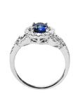 1.08 ct oval blue sapphire ring in 14K white gold with diamond halo and pavé band.
