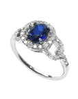 1.08 ct oval blue sapphire ring in 14K white gold with diamond halo.
