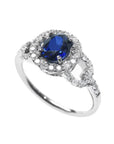 1.08 ct oval blue sapphire ring in 14K white gold with diamond halo.