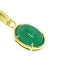 Gold pendant with an oval cabochon emerald pendant right ide profile view.