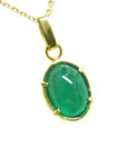 Gold pendant with a natural cabochon emerald pendant topside view.
