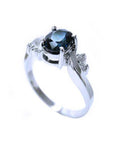 14K white gold ring with a sparkling deep blue oval-cut sapphire and accent diamonds.