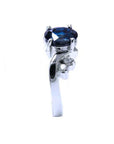 14K white gold ring with a 1.43 ct oval deep blue sapphire and accent diamonds.