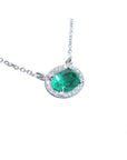 Oval cut emerald necklace east west orientation halo natural diamonds prong set crafted in 14k white gold
