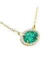 Emerald necklace oval cut east west orientation from Muzo mines Colombia halo natural diamonds, crafted in 14k yellow gold