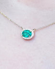 Halo natural diamond Emerald necklaces for sale from Muzo mines Colombia, crafted in 14k yellow gold