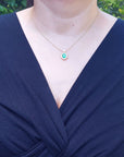 Emerald women's necklaces natural Muzo mine oval cut 1.11 carats encircled by halo diamonds crafted in 14k yellow gold