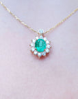 Colombian Emerald necklaces natural Muzo mine oval cut 1.11 carats encircled by halo diamonds crafted in 14k yellow gold