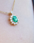 Natural Emerald necklaces Muzo mine oval cut 1.11 carats encircled by halo diamonds crafted in 14k yellow gold