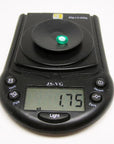 Oval cut loose natural colombian emerald on digital pocket scale showing weight
