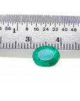 Oval cut loose natural colombian emerald front side table and crown view with ruler for measuring size