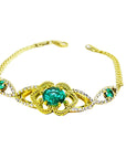 Vintage 14K yellow gold bracelet with a central oval emerald and diamond accents.