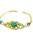 Vintage 14K yellow gold bracelet with a central oval emerald and diamond accents.