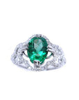 This oval-cut emerald, elegantly set at the heart of a four-leaf clover design framed by a halo of diamonds is in 14K gold.