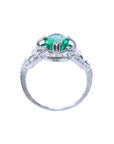 1.55 ct oval emerald clover ring with diamond halo in 14K white gold.