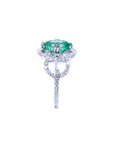 1.55 ct. oval emerald clover ring with diamond halo in 14K white gold.