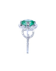 1.55 ct. oval emerald clover ring with diamond halo in 14K white gold.