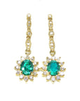 A pair of oval cut emerald halo diamond dangle earrings yellow gold