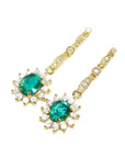 A left side position of a pair of earrings oval cut emerald dangle top side view