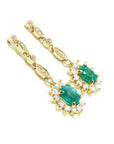 Right position a pair of a 14k yellow gold emerald earrings halo diamonds, side profile view