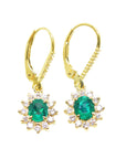 Front position of a pair of oval cut emerald earrings, halo diamonds in yellow gold, top side view