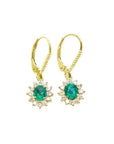 14K gold oval cut Colombian emerald earrings with diamond halo and lever backs.