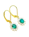 Gold earrings with oval cut natural emeralds and halo diamond in 14k yellow gold right side top view