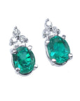 Pair of natural oval emerald earrings with diamond accents in 14k white gold, May birthstone.