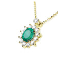 14K yellow gold necklace with oval emerald (1.11 ct) and natural diamond halo pendant.