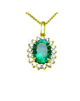 Oval 3.01 ct. natural emerald pendant with halo diamonds in 18K yellow gold.