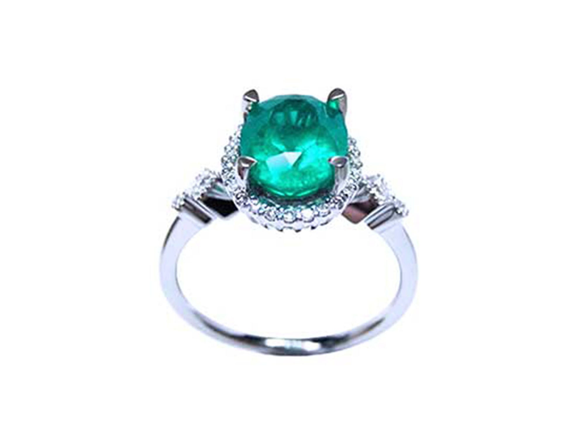 A natural oval emerald ring with accent diamonds in white gold, top and lateral view.