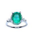 The topside view of an oval emerald ring, with accent diamonds, perfect for mother's day gift.